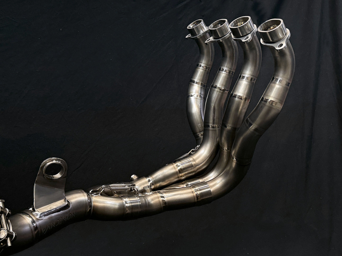 A close-up of four exhaust pipes arranged together
