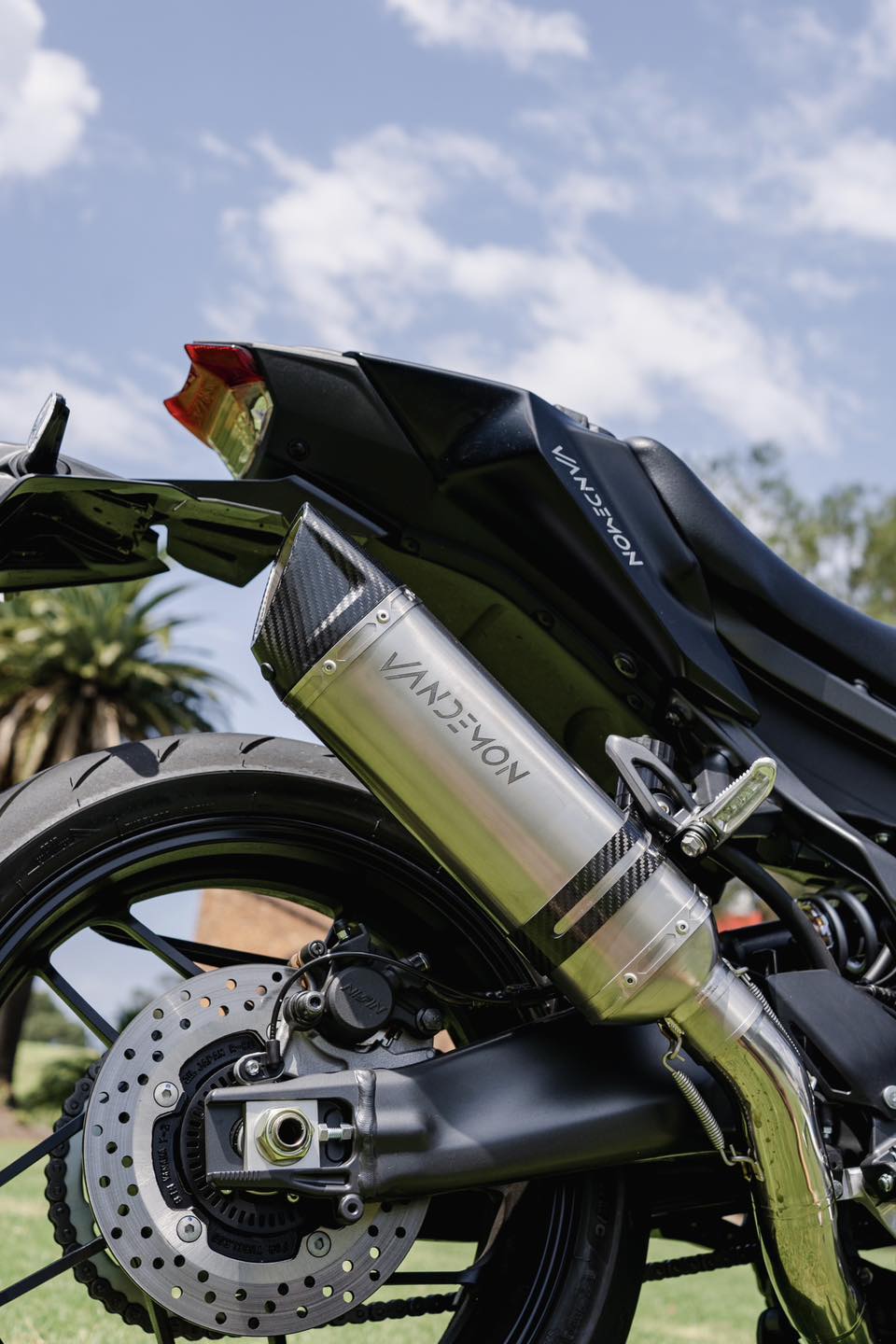Close-up of a motorcycles rear section featuring a Vandemon carbon fiber exhaust.