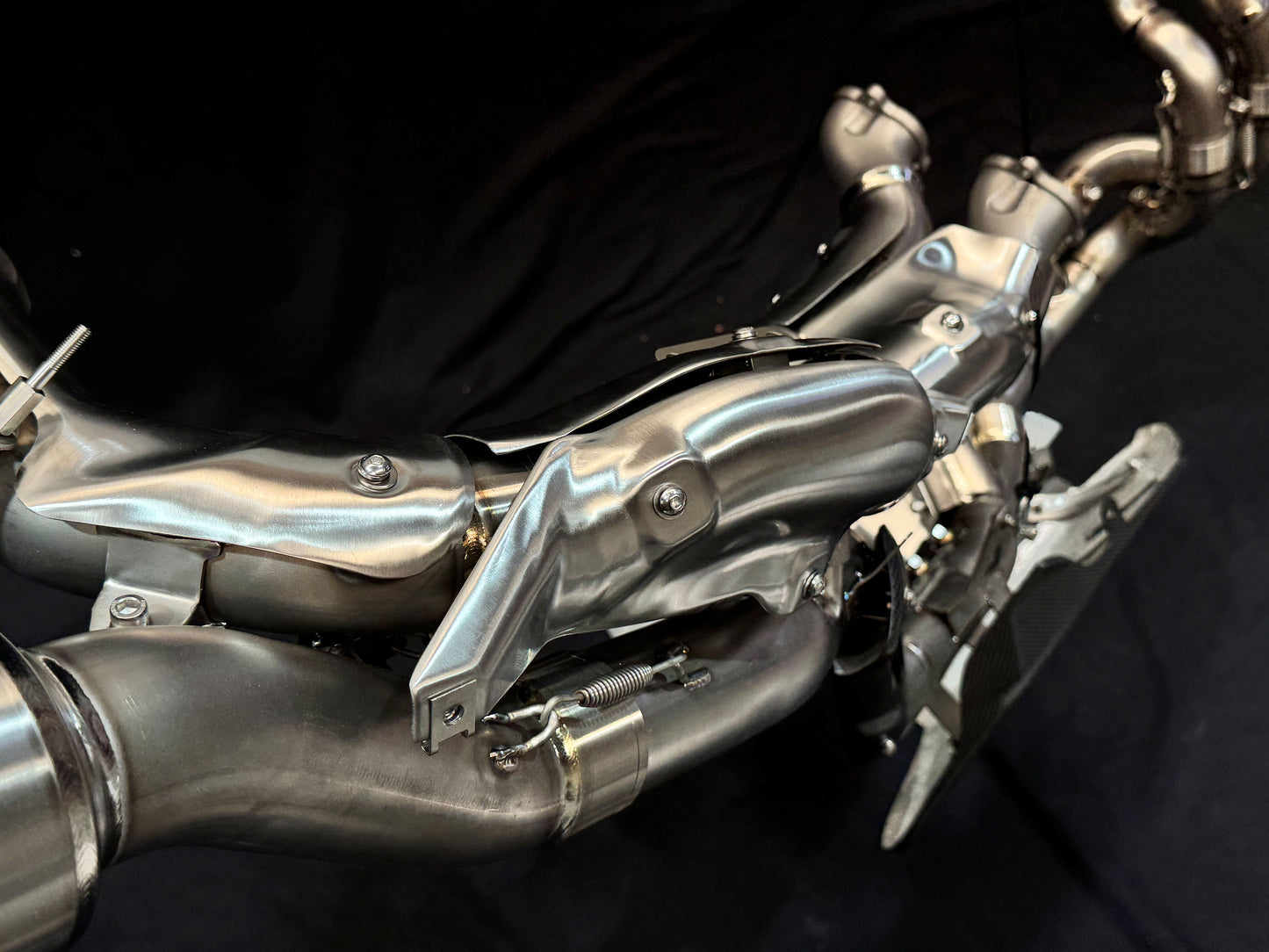 Close-up of a metallic exhaust on a black background