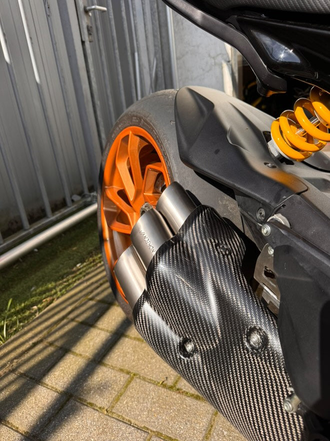 Close-up of a motorcycle's carbon fiber exhaust cover