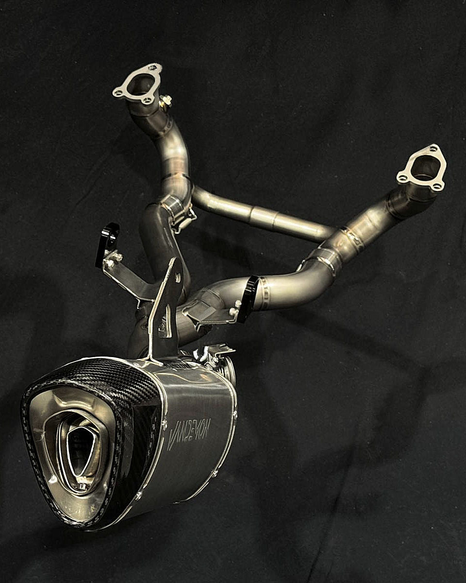 Detailed view of a motorcycle exhaust pipe with two pipes connected