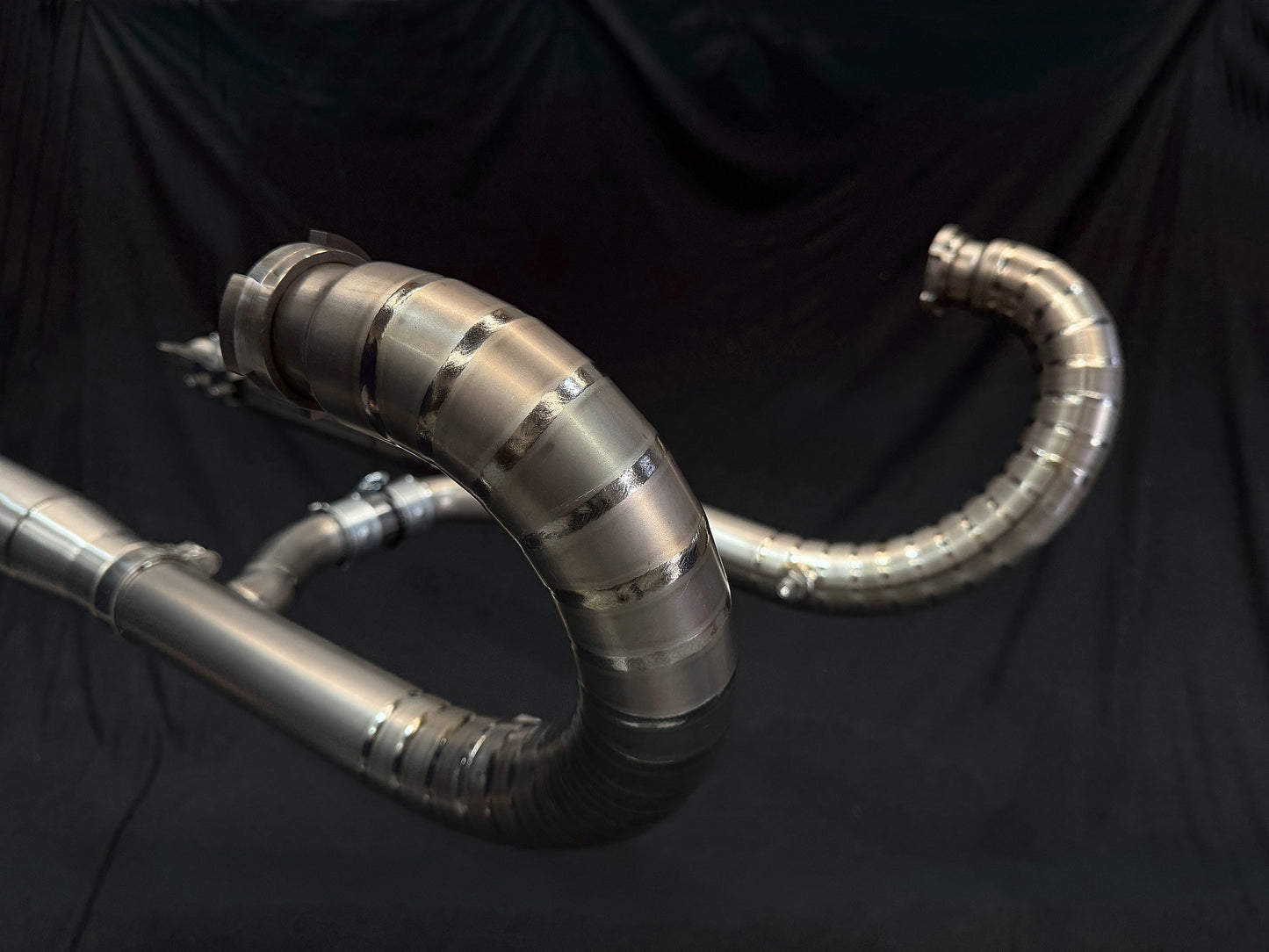 Detailed view of a metal pipe set against a black background