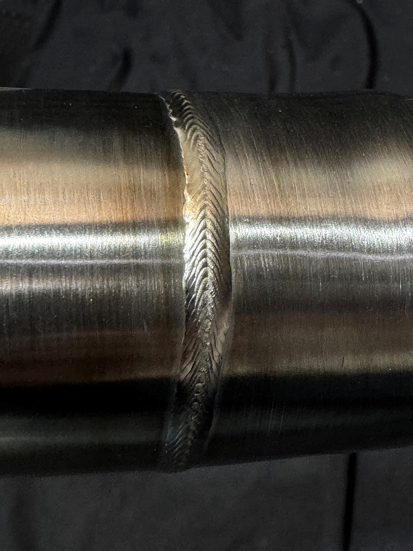 A close up of a brushed finish in motorcycle pipe.