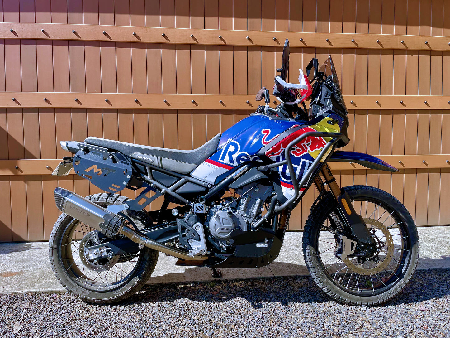 A motorcycle is parked in front of a garage