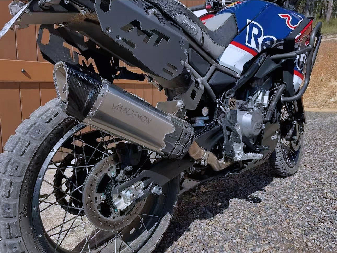 A motorcycle adorned with a striking red, white, and blue stripe, emphasizing its exhaust.
