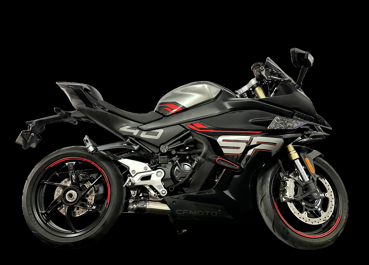 A motorcycle displayed prominently against a solid black background, highlighting its sleek design and exhaust from vandemon.