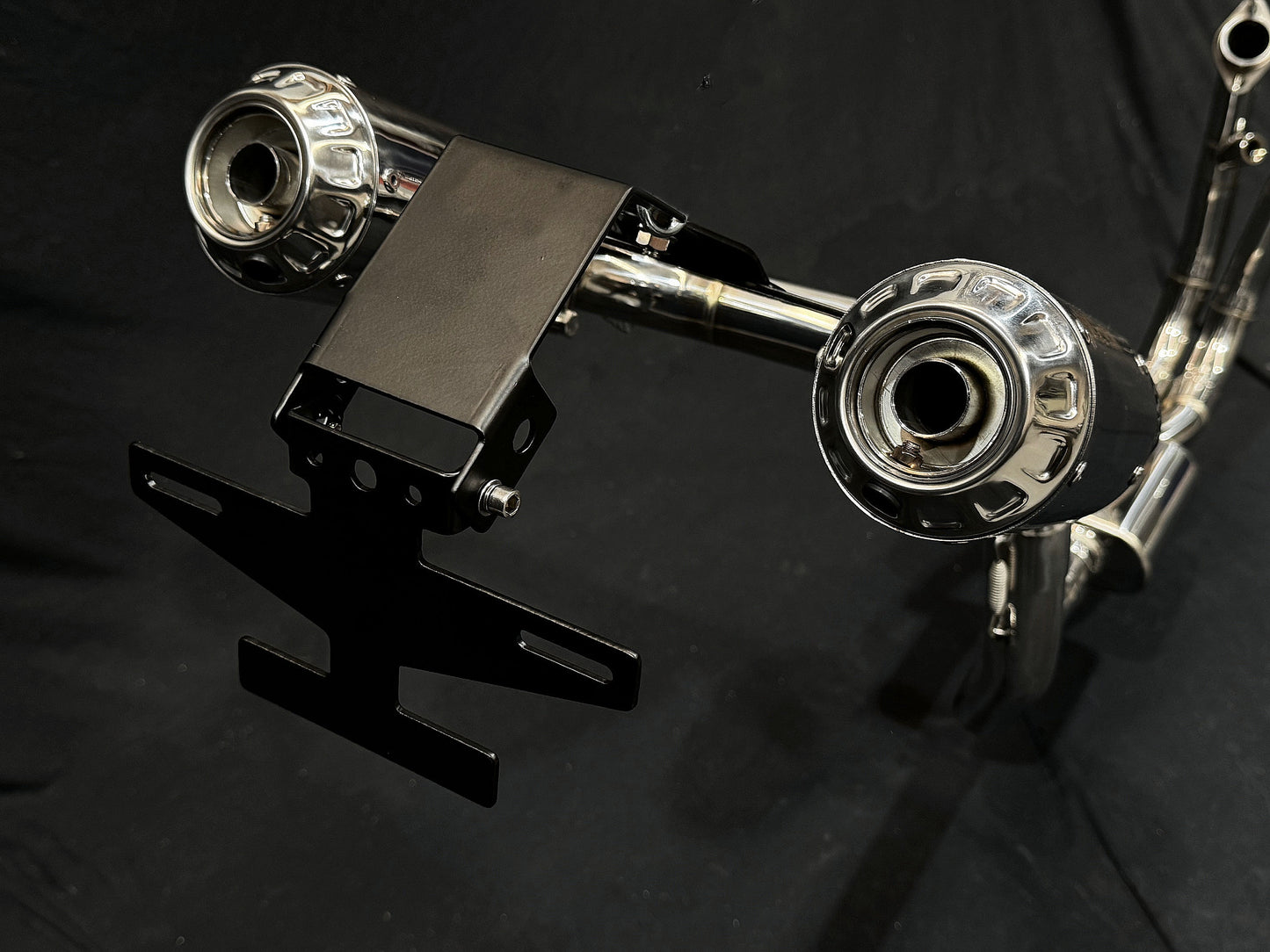 Detailed view of a motorcycle highlighting two exhaust pipes