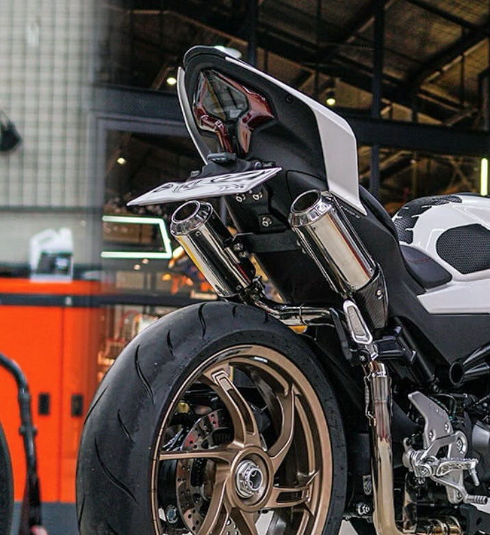 A white and black motorcycle parked in a spacious garage