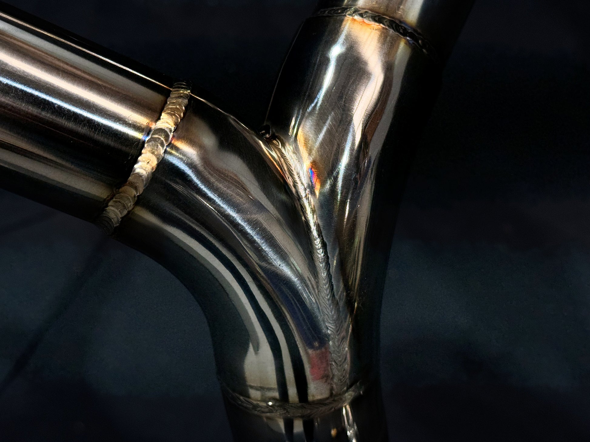 Y-shaped polished metal pipe joint with clean TIG welds at each connection, showcasing high precision fabrication and structural integrity.