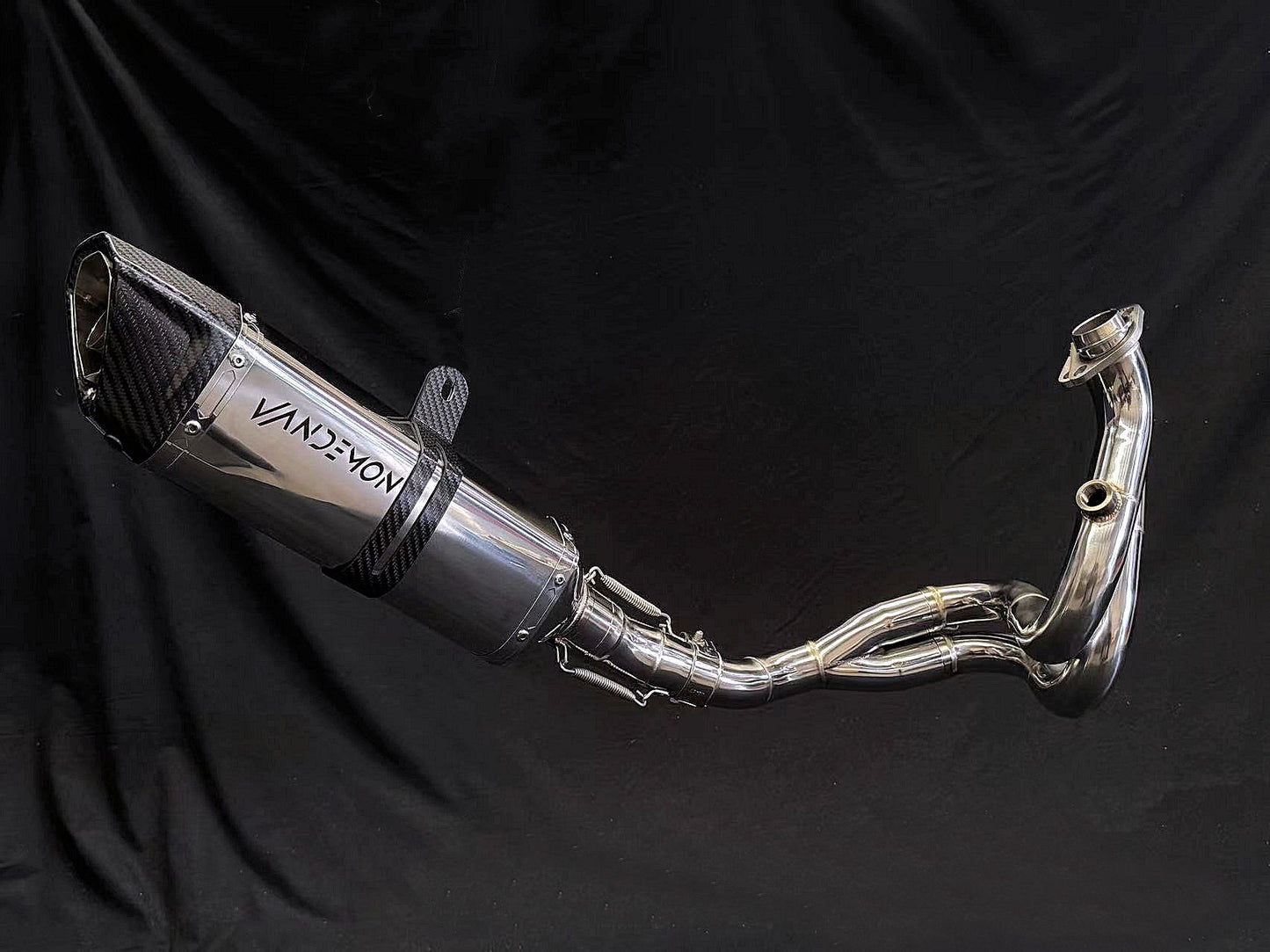 Reflective metallic finish on dual-exhaust motorcycle system.