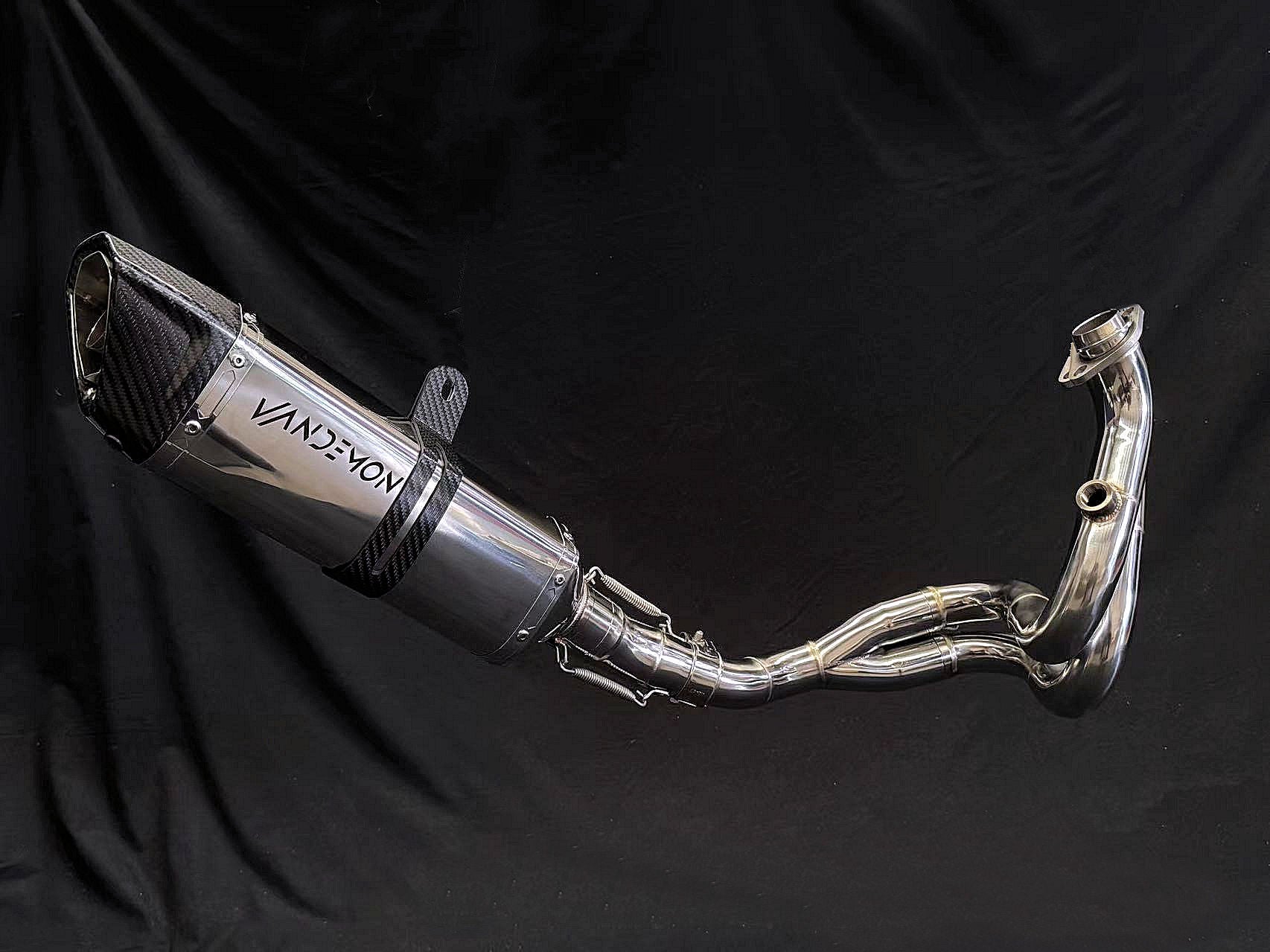 Reflective metallic finish on dual-exhaust motorcycle system.