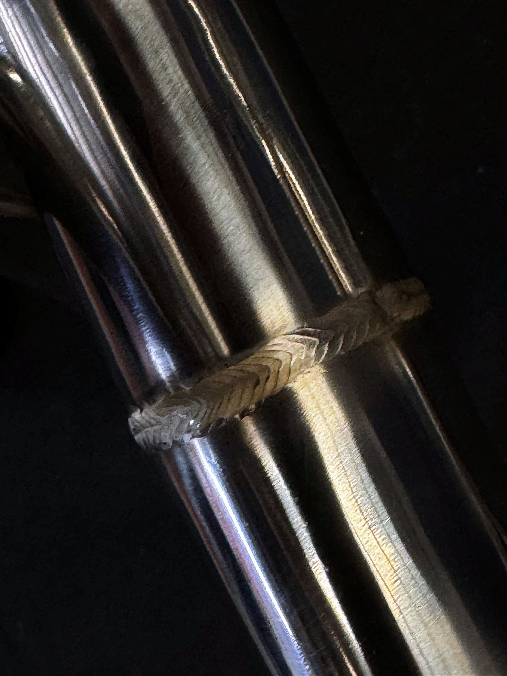 Sleek, metallic dual-exhaust system on motorcycle, close-up view.