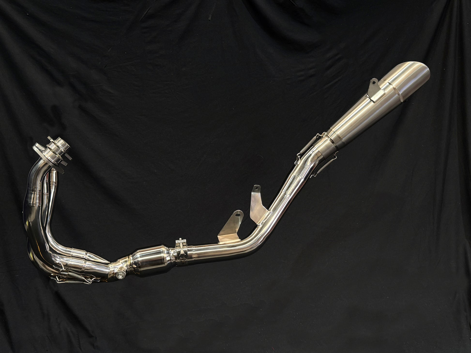 Side Mount Titanium Exhaust System on a black backdrop.