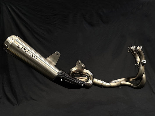 Close-up of motorcycle dual-exhaust system, shiny metallic finish.