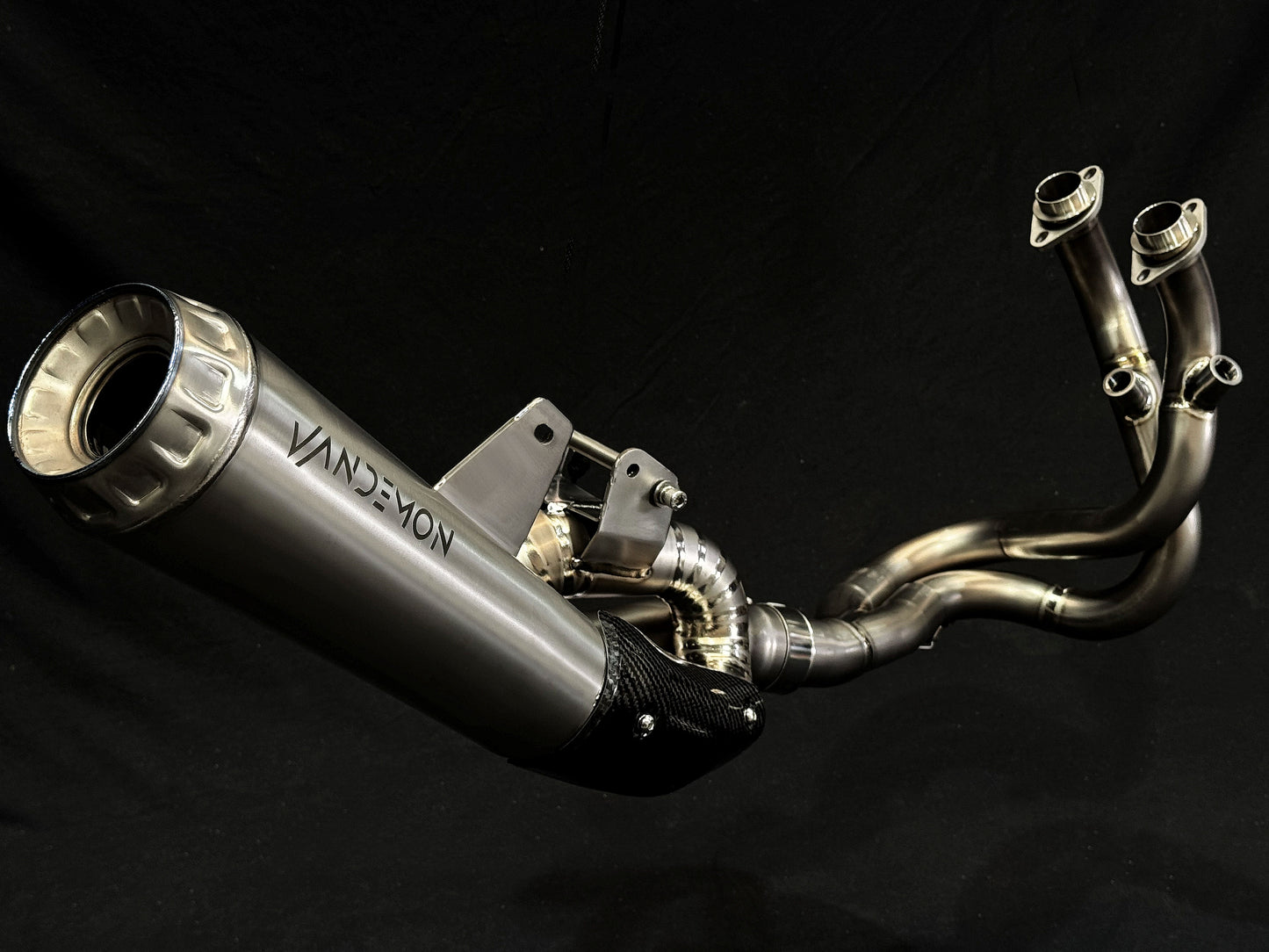 Modern dual-exhaust motorcycle system with metallic finish.