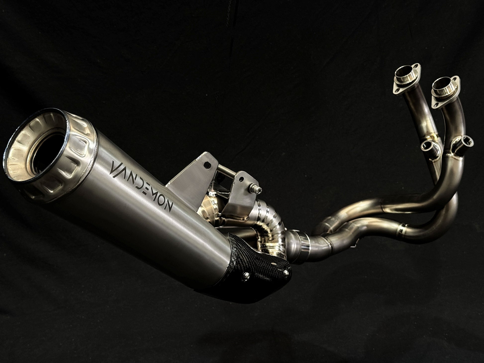 Modern dual-exhaust motorcycle system with metallic finish.