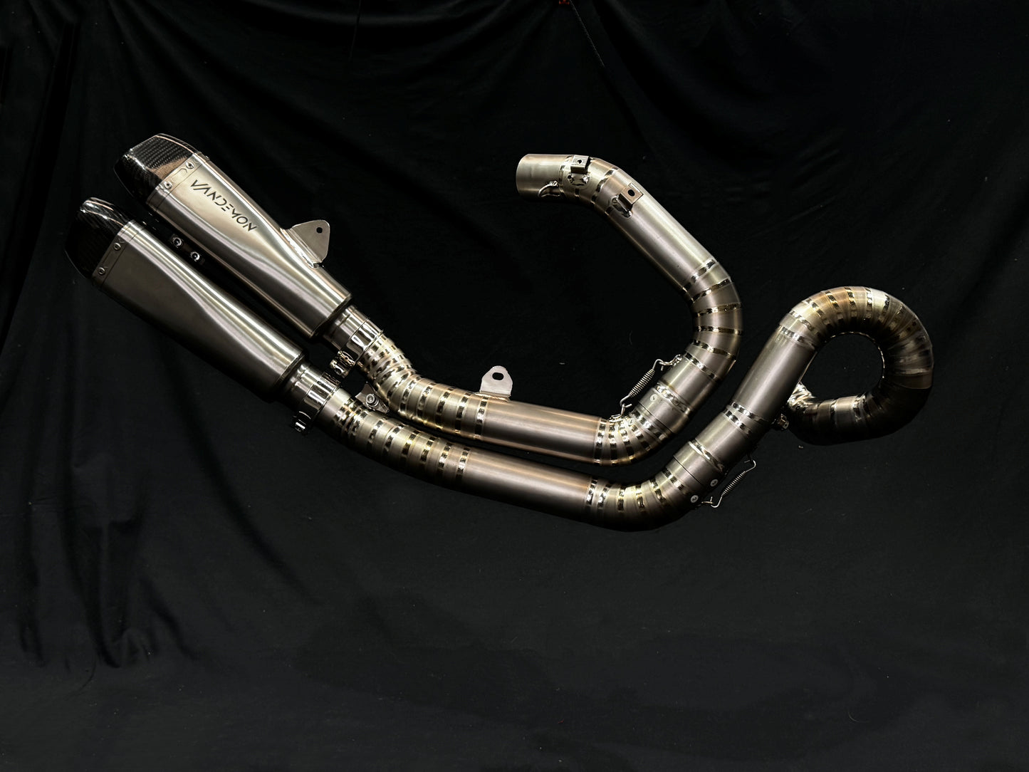 A motorcycle's into two titanium exhausts system.