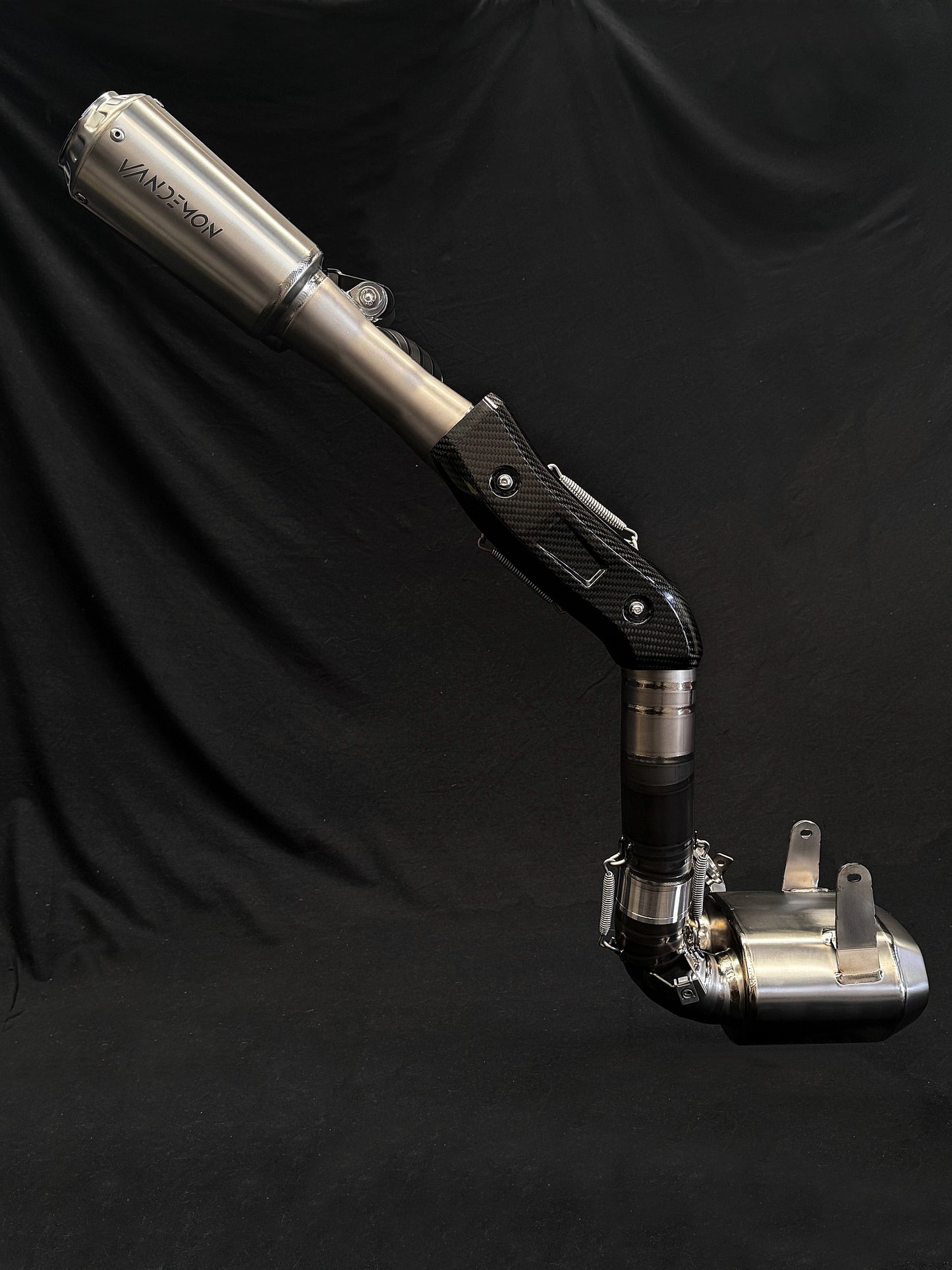 Modern dual-exhaust motorcycle system with metallic finish.