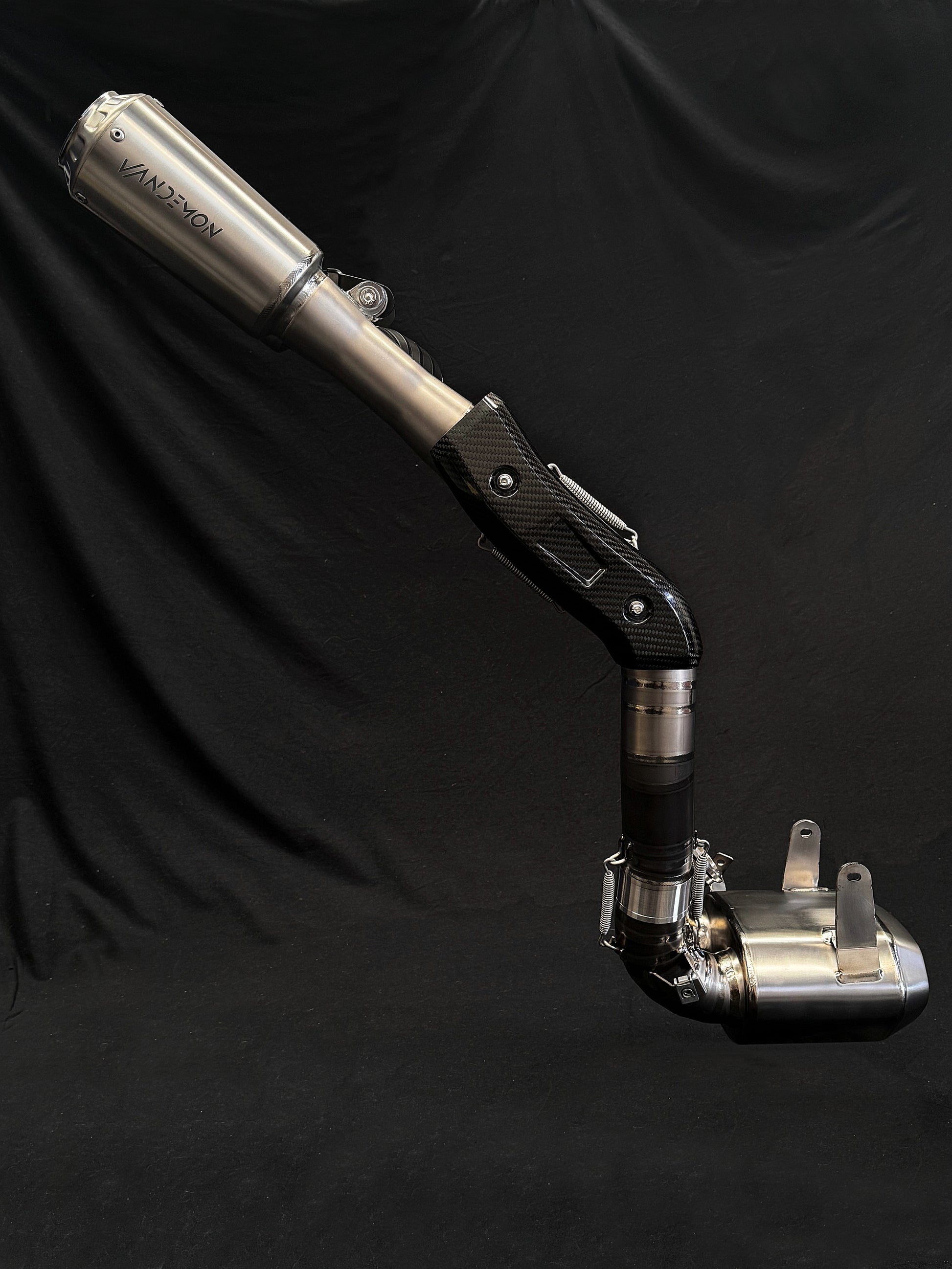 Modern dual-exhaust motorcycle system with metallic finish.