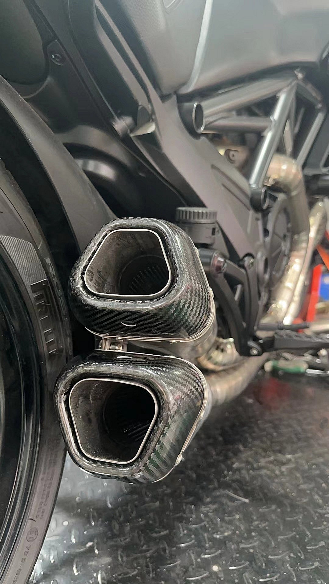 A motorcycle's split pulse titanium mufflers baffles out.