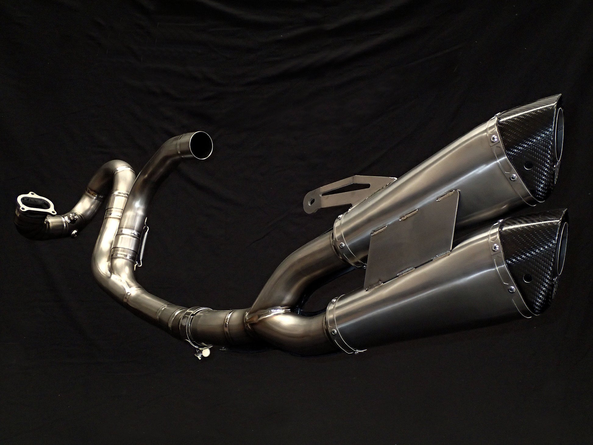 Modern motorcycle exhaust system with intricate details, close-up.