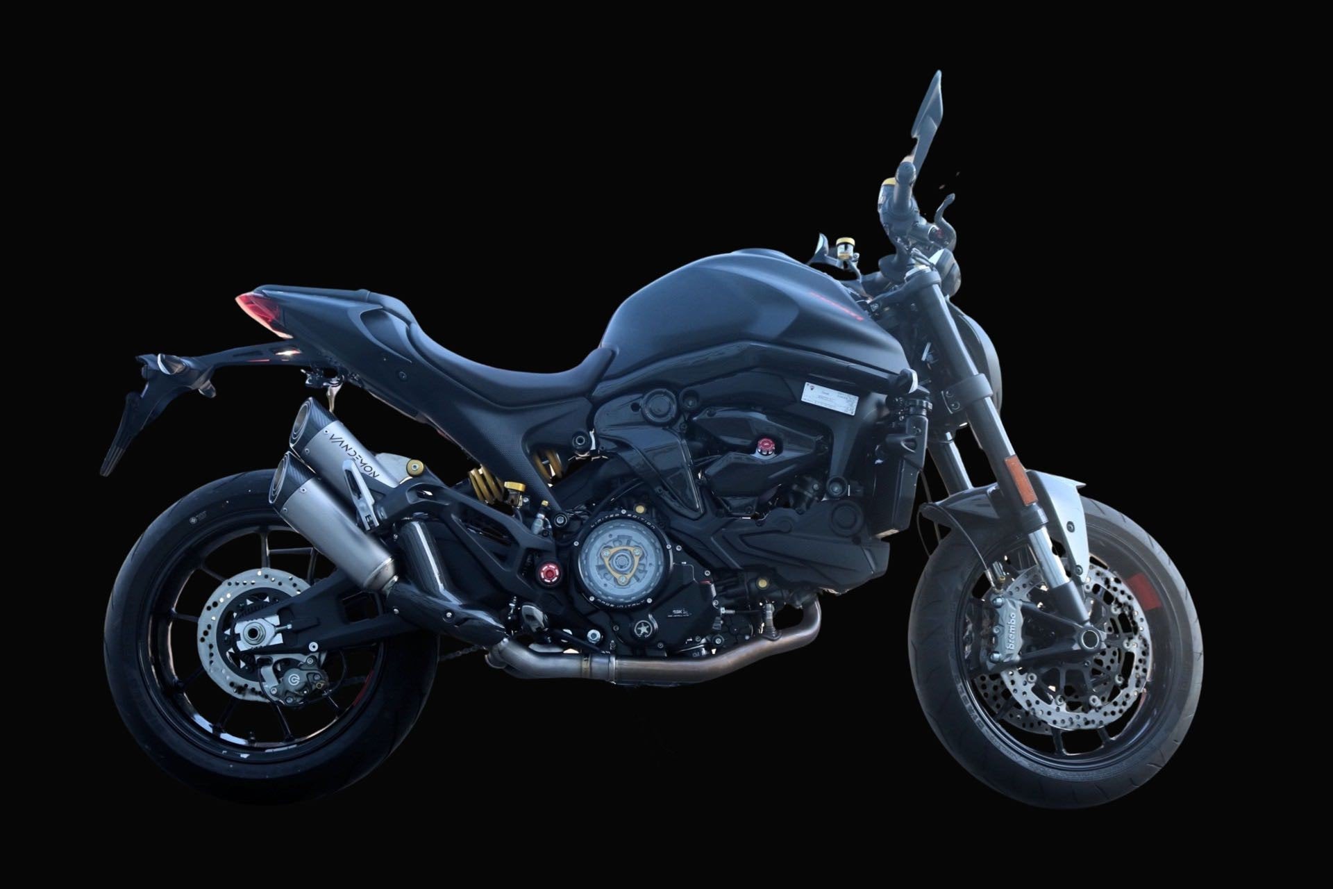 A sleek black motorcycle shown in profile view against a solid black background.