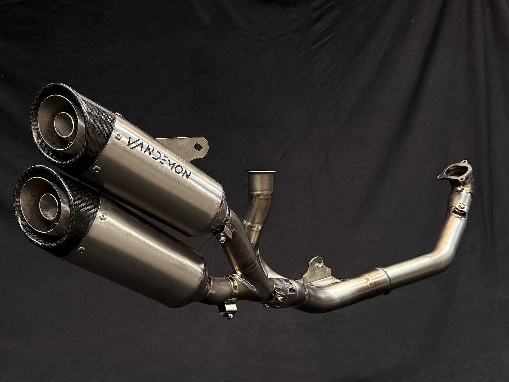Reflective metallic finish on dual-exhaust motorcycle system.