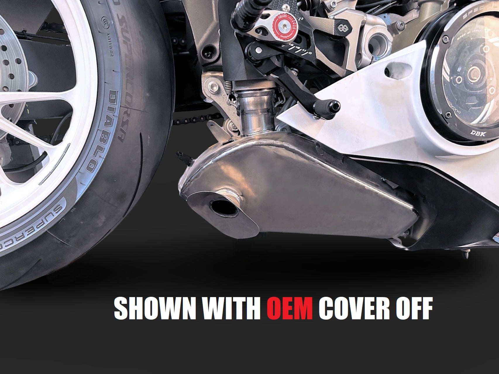 Close-up of motorcycle wheel and suspension shown with OEM cover off