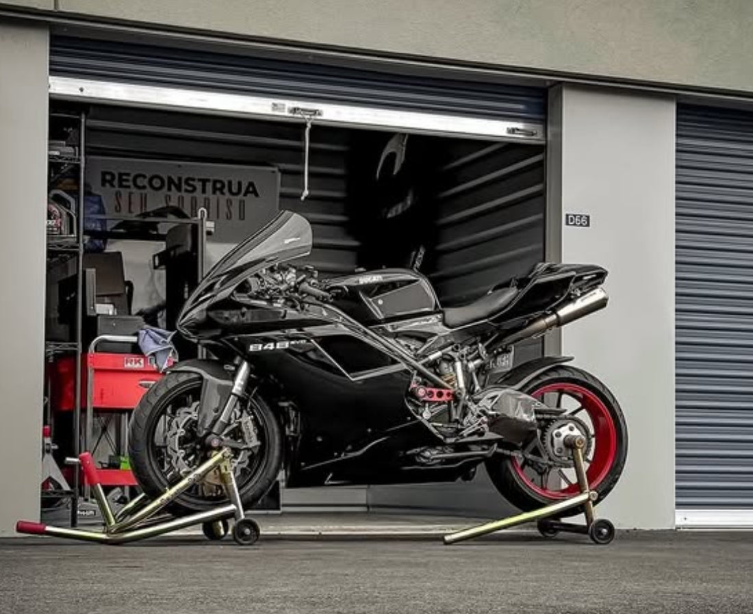 A black motorcycle parked in garage.