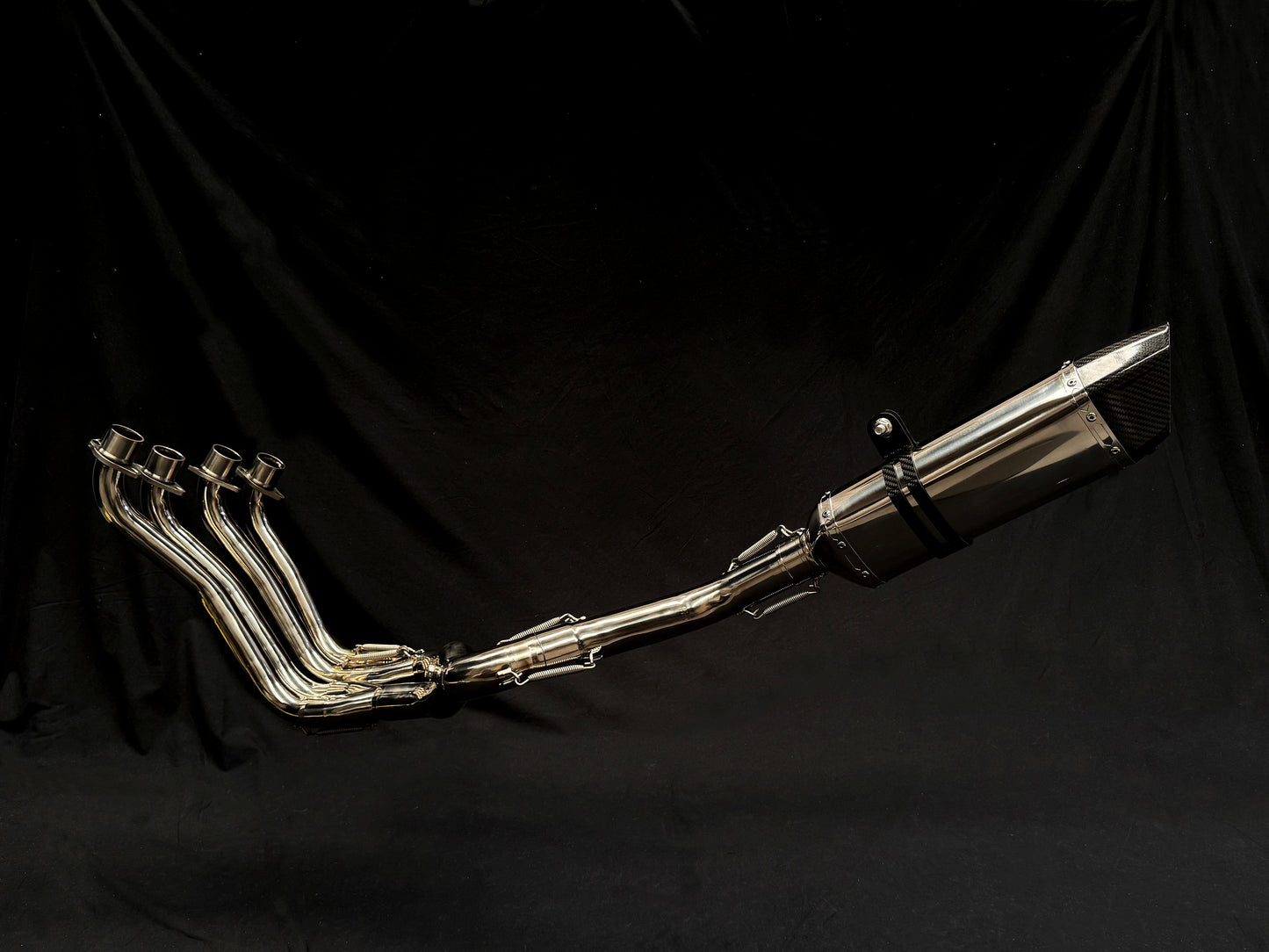 Close-up of a silver exhaust pipe with four individual pipes