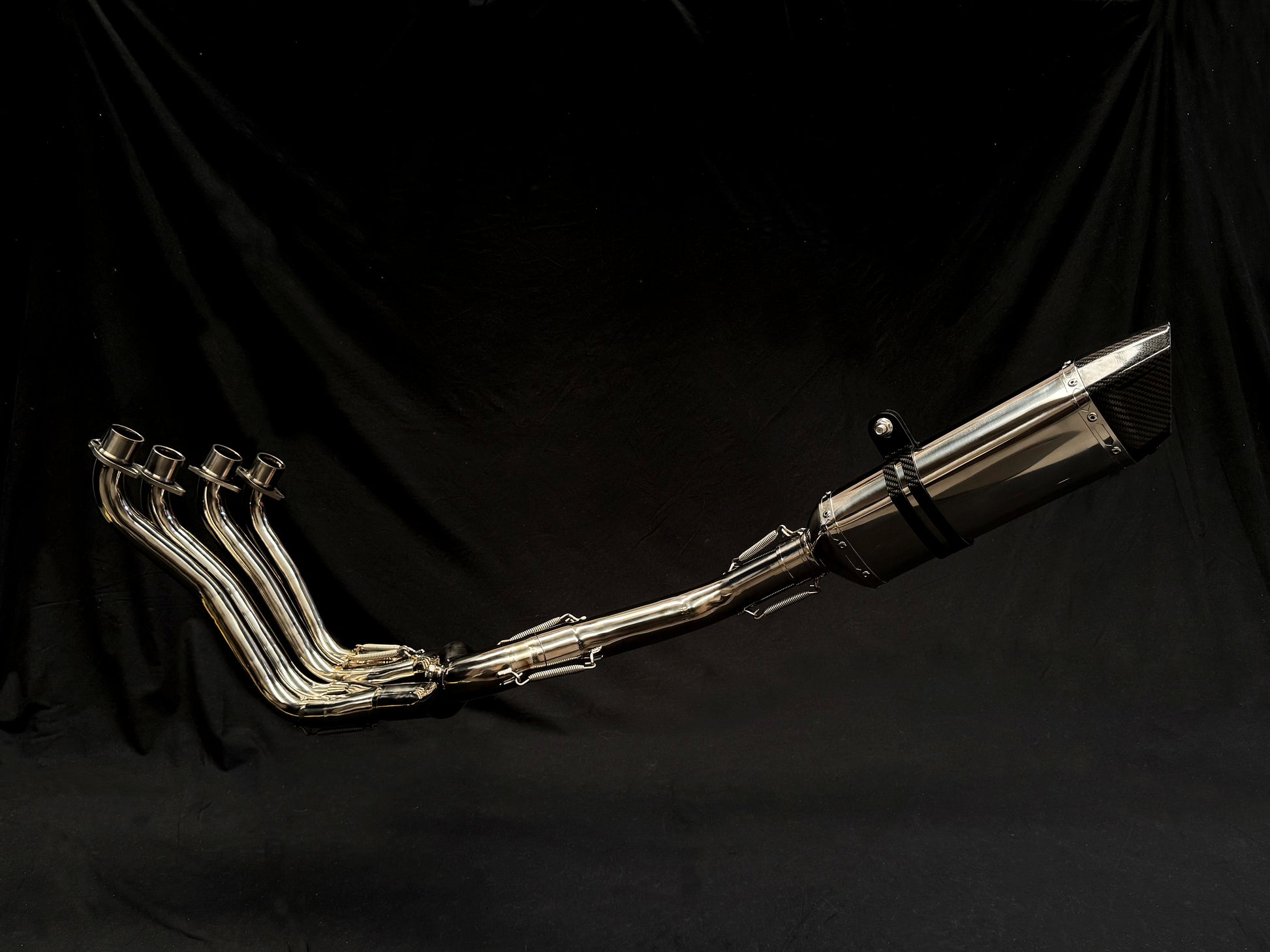 Close-up of a silver exhaust pipe with four individual pipes