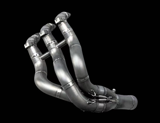 Metallic exhaust manifold on a black background