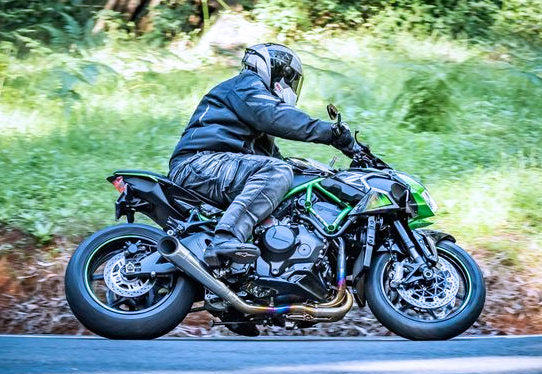 man riding a green sport bike