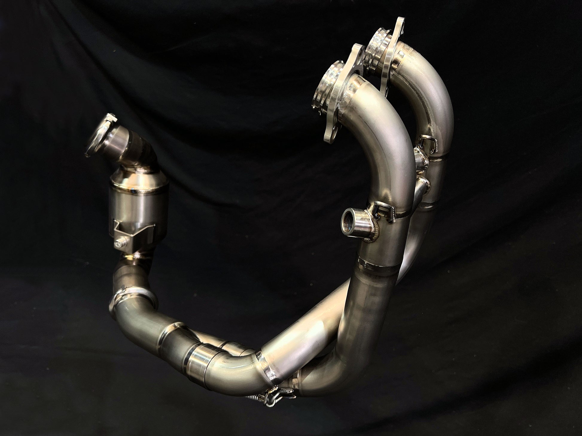 Detailed close-up of a stainless steel exhaust pipe, highlighting its polished surface and sleek design.