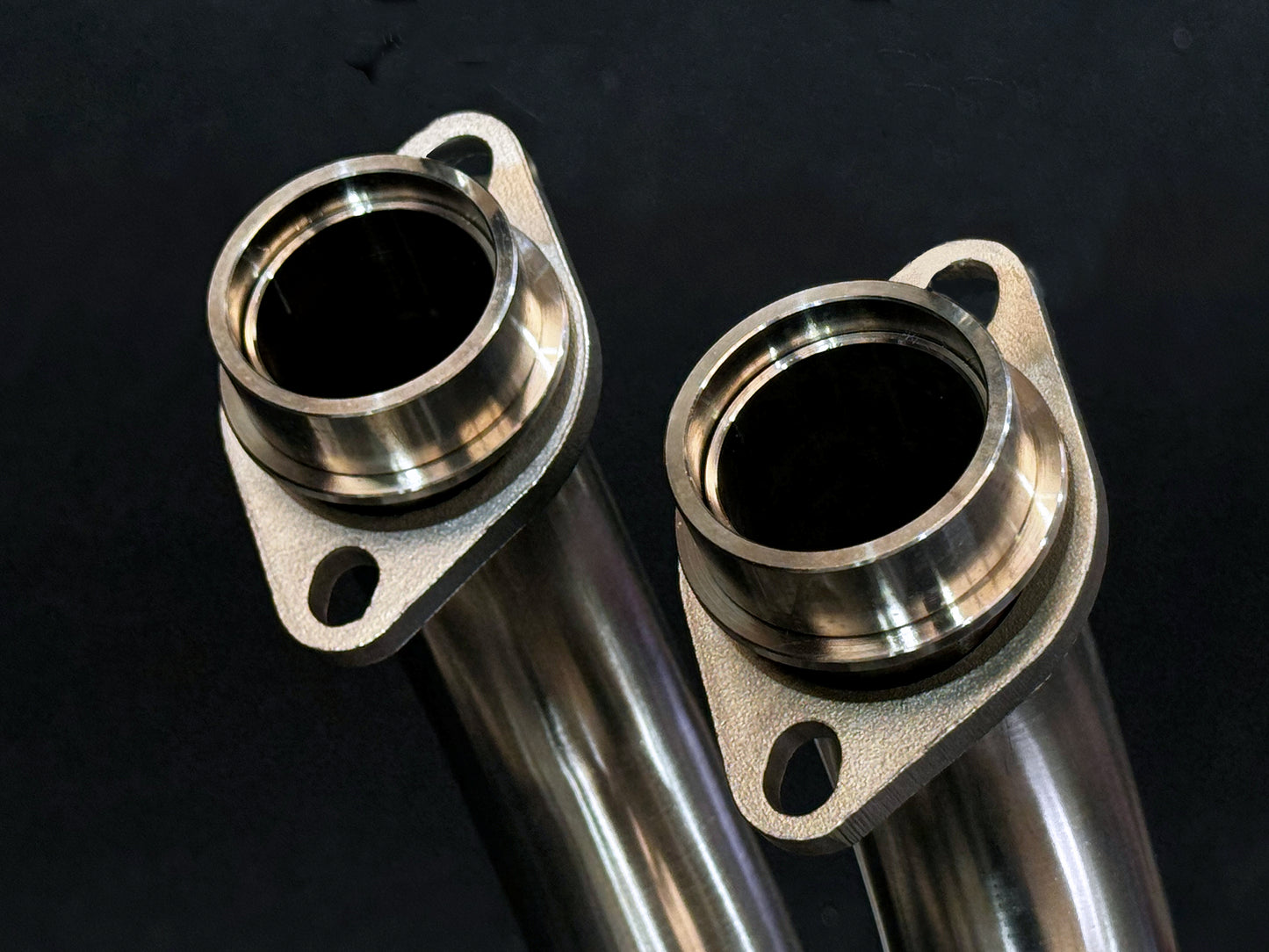 A close up view of a motorcycle's stainless steel spigots.