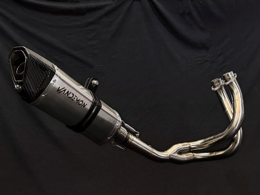 A close up view of a motorcycle's stainless steel exhausts.