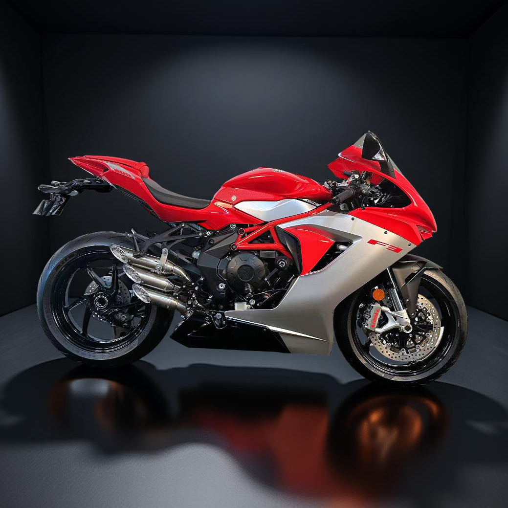 Red and white motorcycle on a reflective surface with dark background