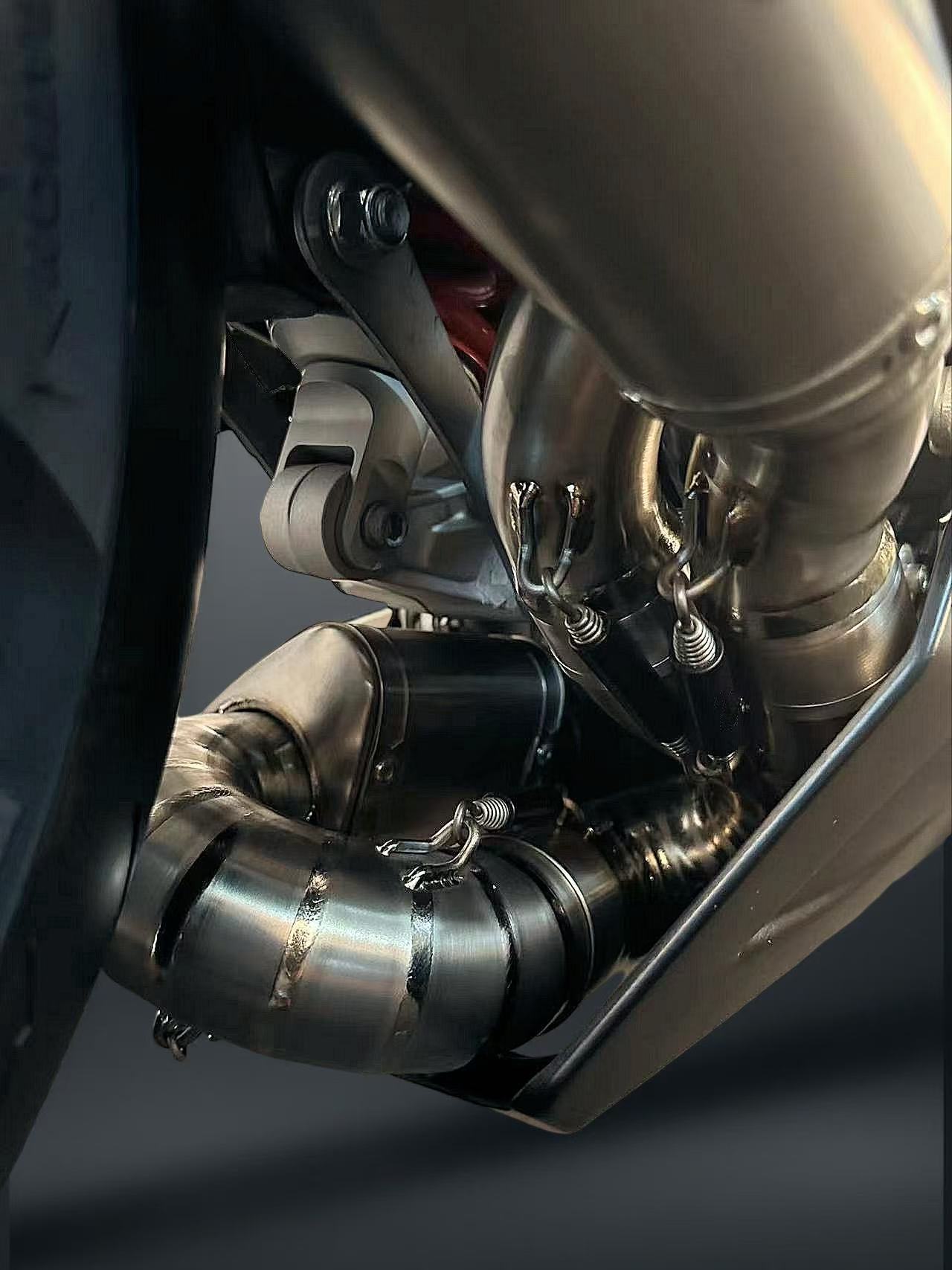 Close-up of a motorcycle exhaust system with metallic components