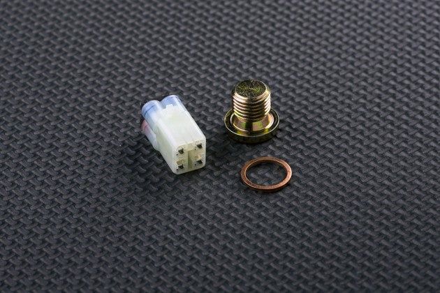 Three automotive parts on a textured gray surface