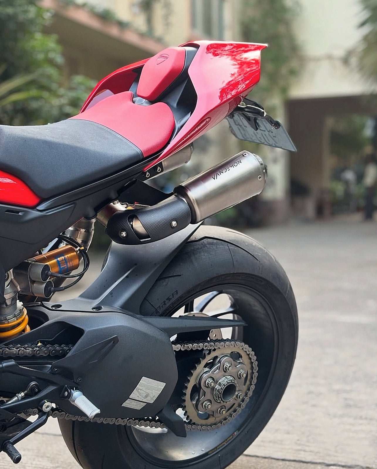 Close-up of a red and black motorcycle parked outdoors.