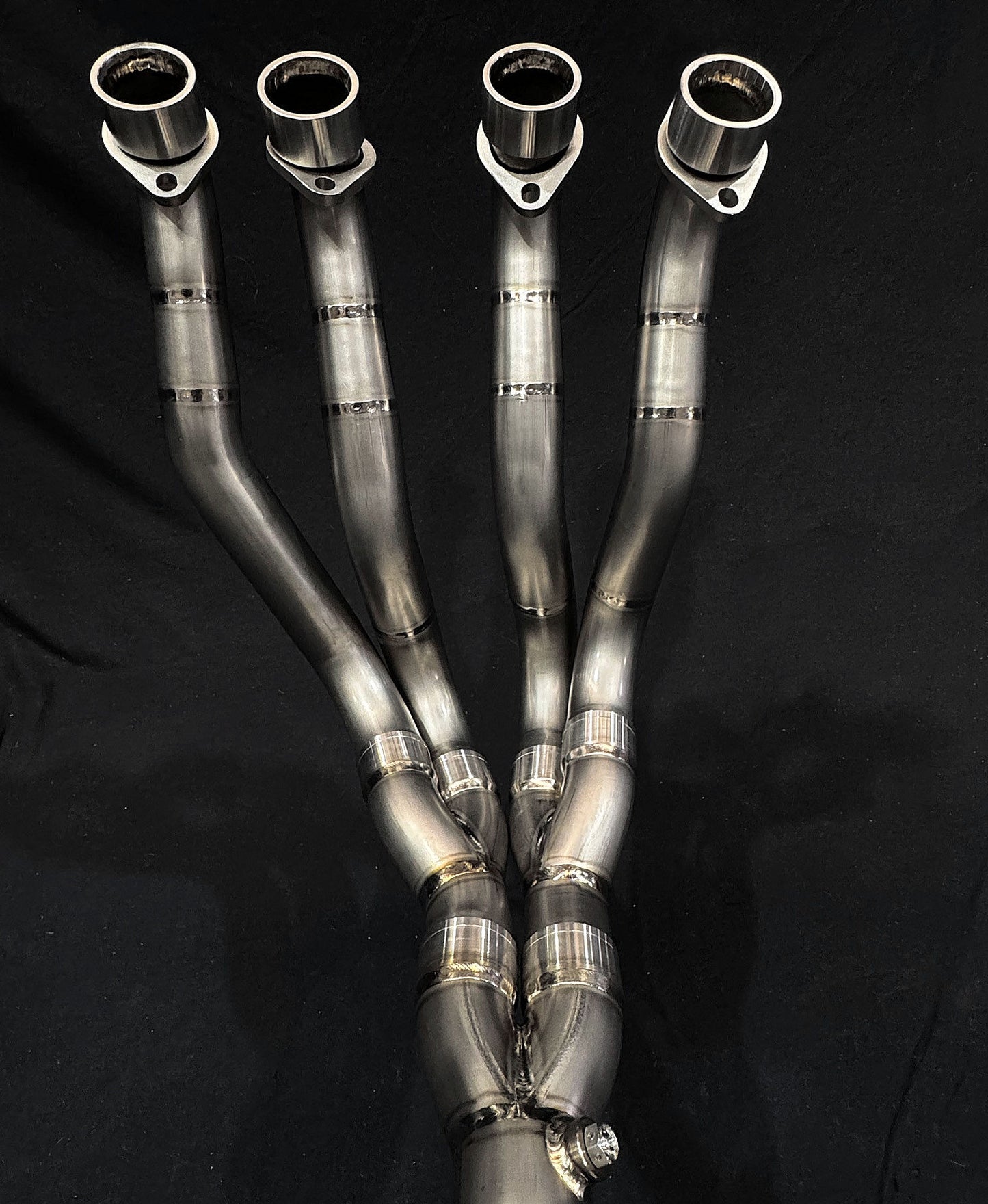 Reflective metallic finish on dual-exhaust motorcycle system.