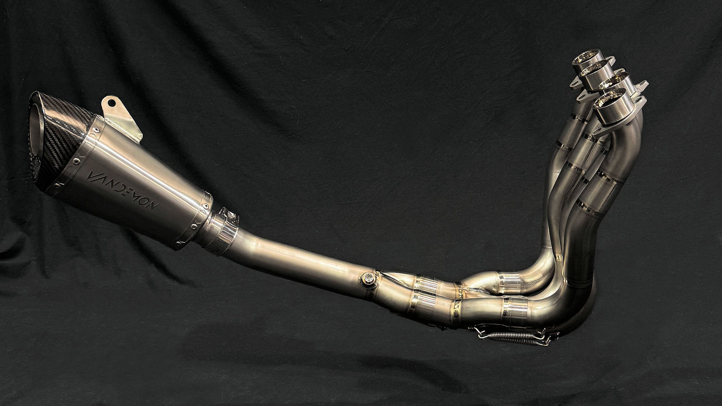 Close-up of dual-exhaust motorcycle system with metallic finish.