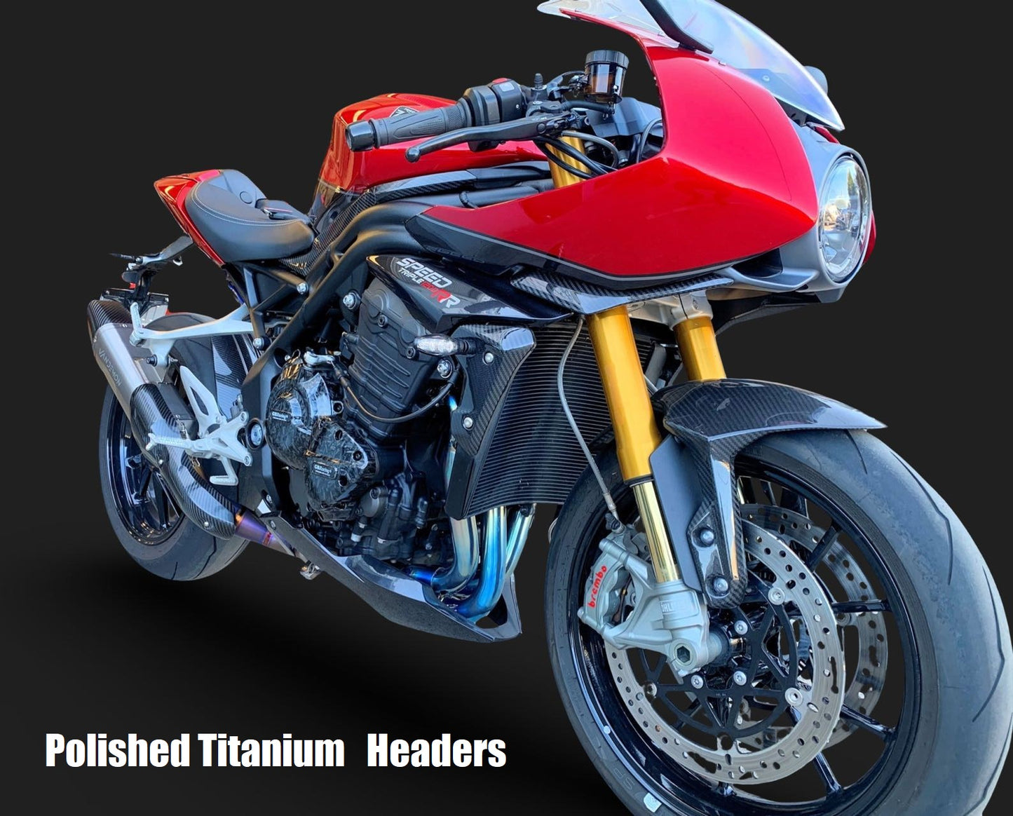 A striking red motorcycle set against a dark black backdrop.