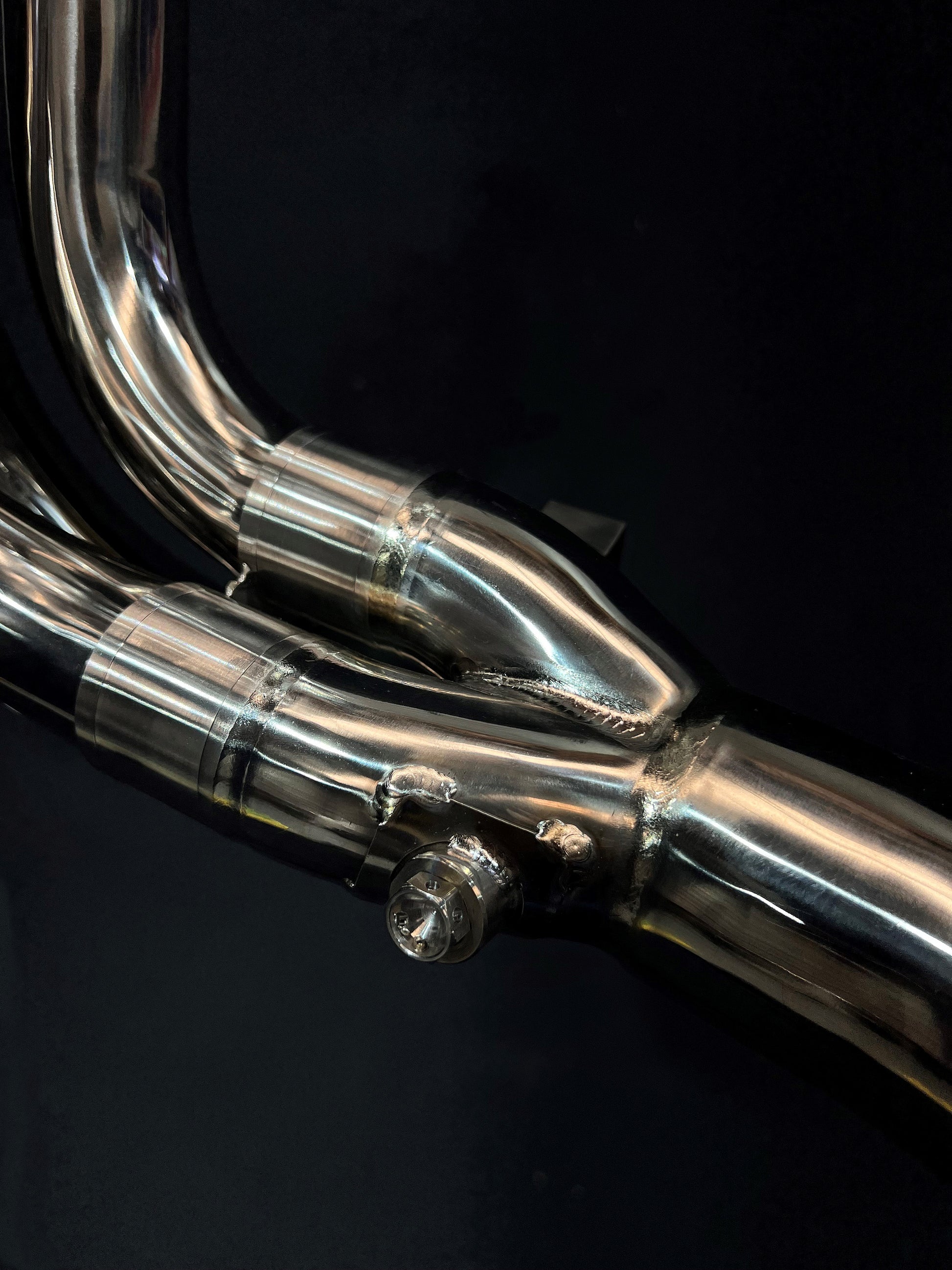 A close up of V4 engine with carbon exhausts system