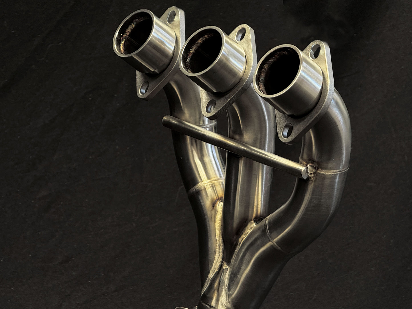 Detailed design of sleek, dual-exhaust motorcycle system.