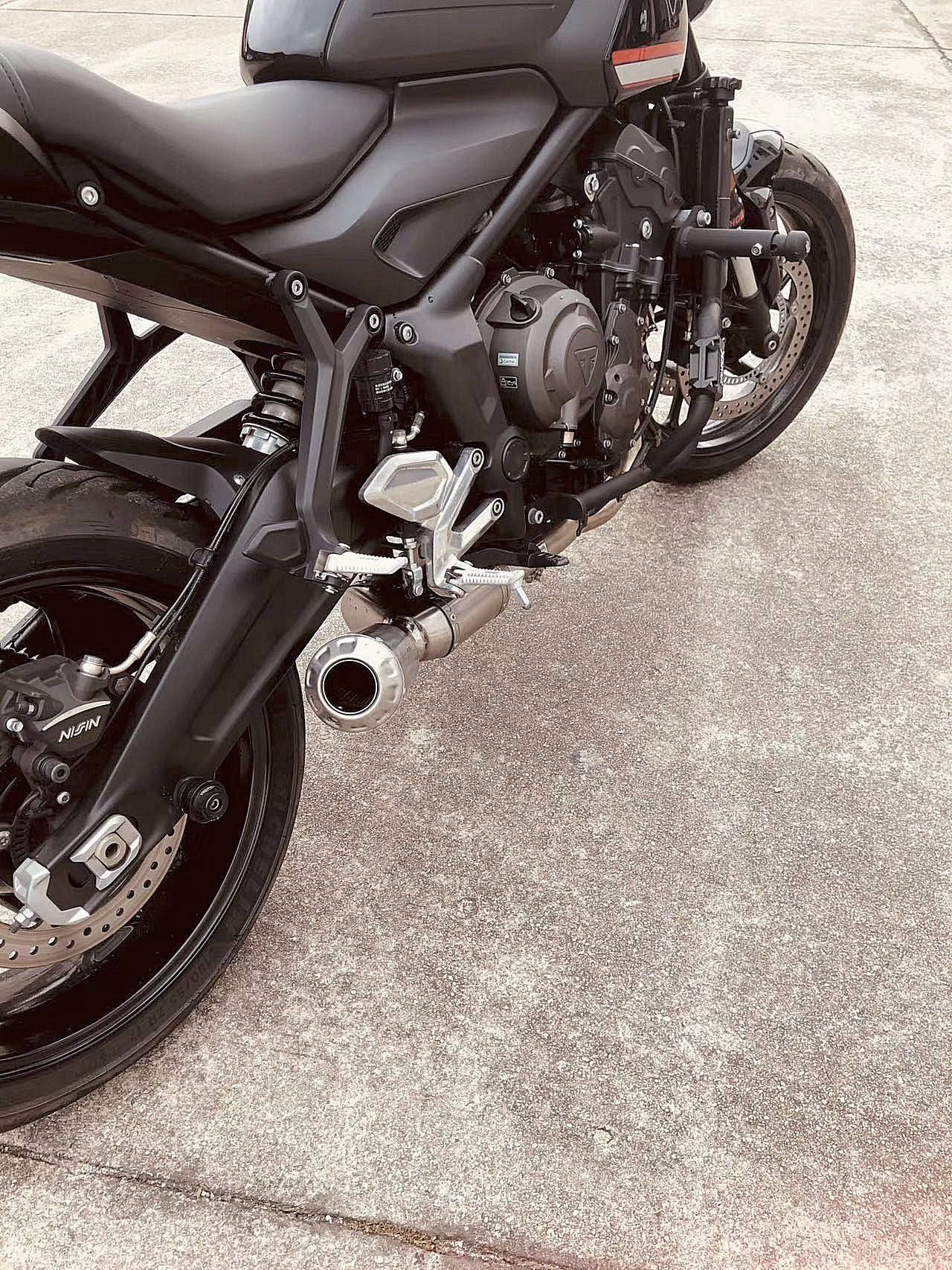 Detailed view of a motorcycle showcasing a prominent black exhaust pipe