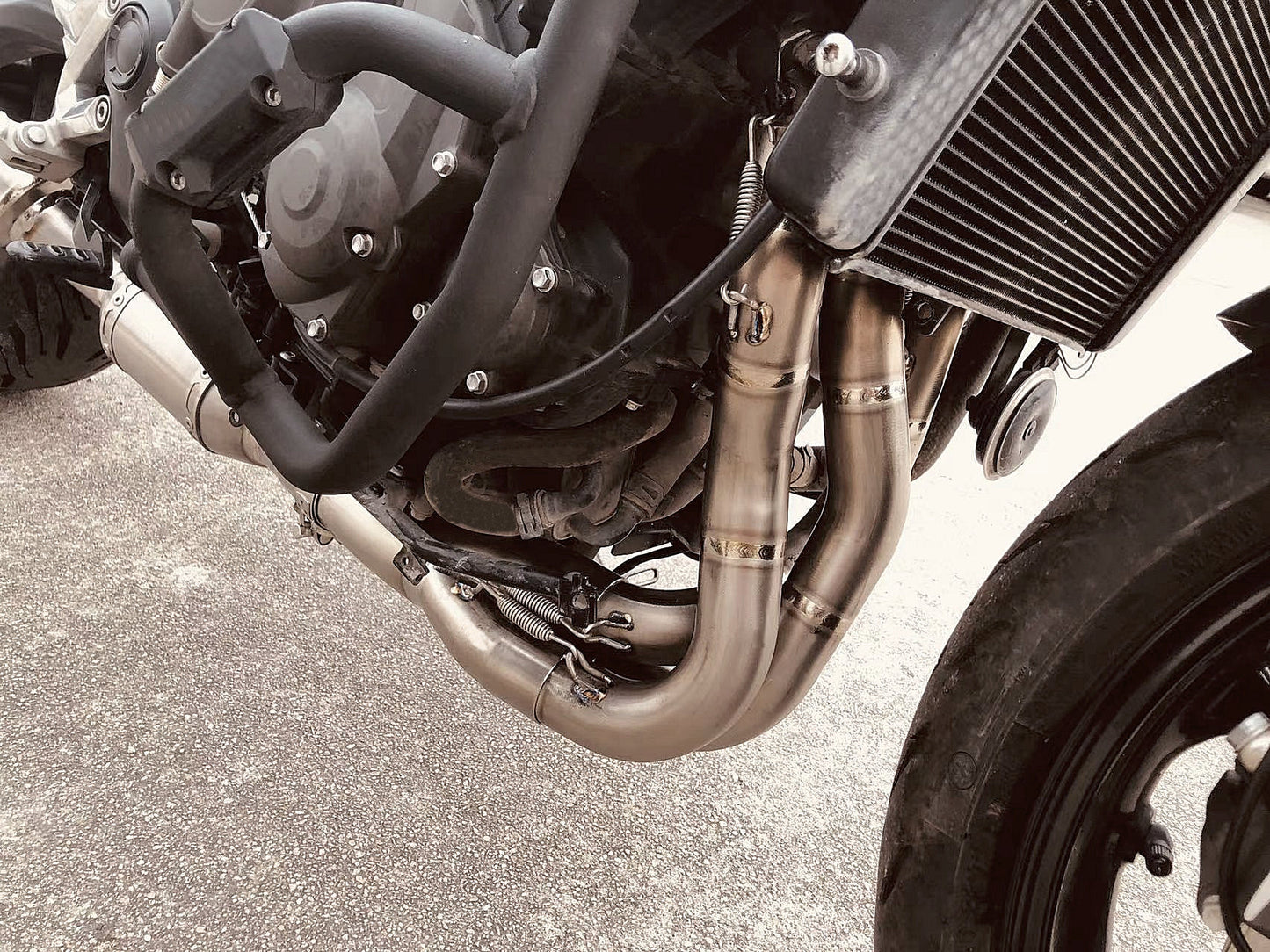 Close-up image of a motorcycle with a distinctive black exhaust pipe