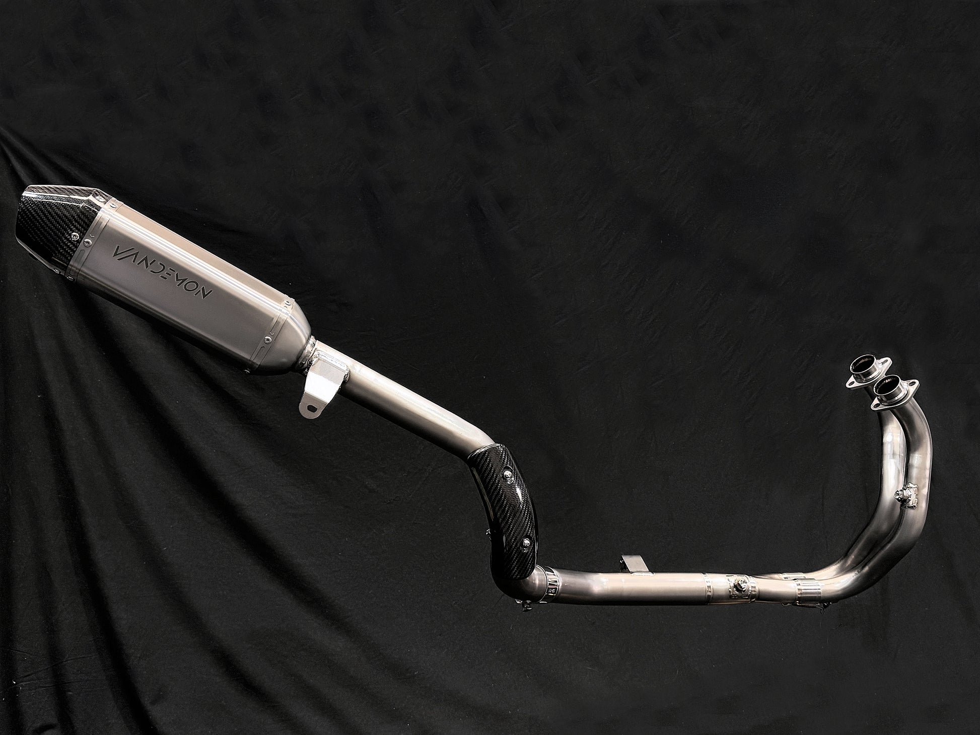 A motorcycle's Titanium Exhaust Cover fitted in a black backdrop.