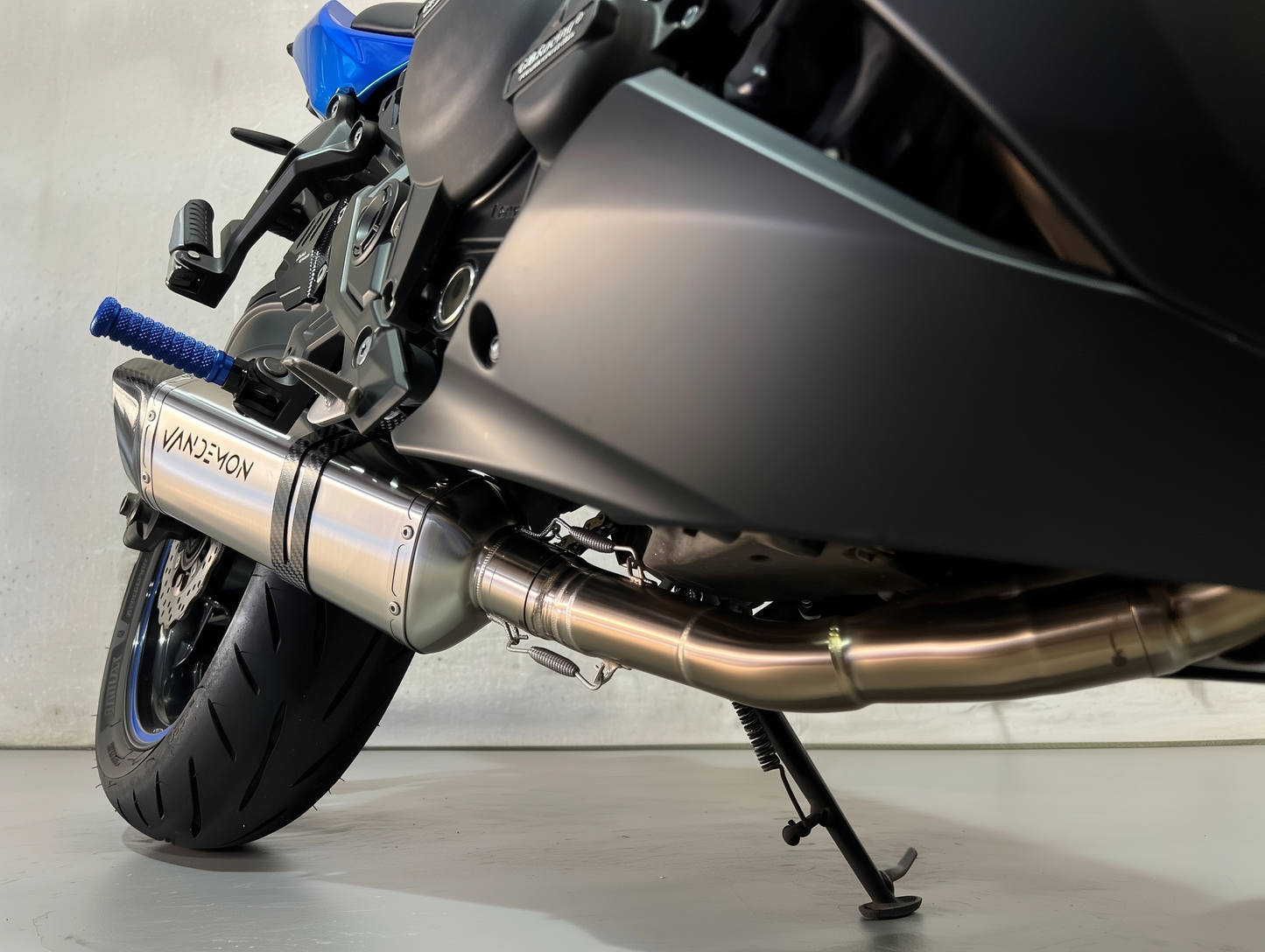 Detailed view of a Titanium Exhausts system baffle removed against a black background.