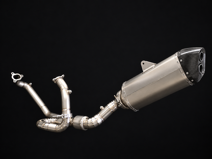 A high-performance motorcycle exhaust system with a brushed silver stainless steel muffler, carbon fiber tailpipe end, and multi-pipe intake tubing, shown against a solid black background.